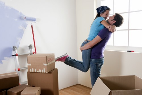Movers handling furniture in a Lewisham residential street